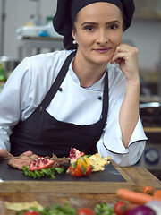Image showing female Chef preparing beef steak