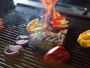 Image showing steak with vegetables on a barbecue