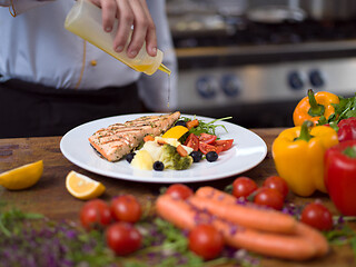 Image showing Chef finishing steak meat plate