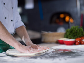 Image showing chef preparing dough for pizza