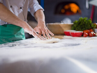 Image showing chef preparing dough for pizza