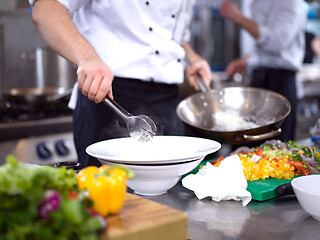 Image showing Chef hands serving spaghetti