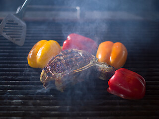 Image showing chef cooking steak with vegetables on a barbecue