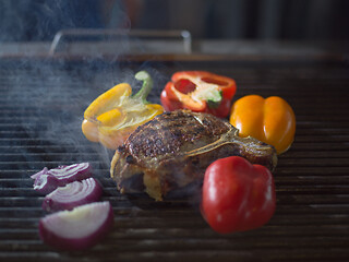 Image showing steak with vegetables on a barbecue