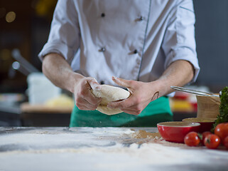 Image showing chef hands preparing dough for pizza