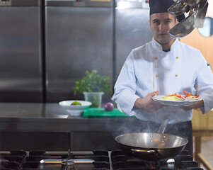 Image showing chef preparing food, frying in wok pan