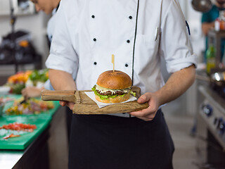 Image showing chef finishing burger