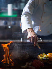 Image showing chef cooking steak with vegetables on a barbecue