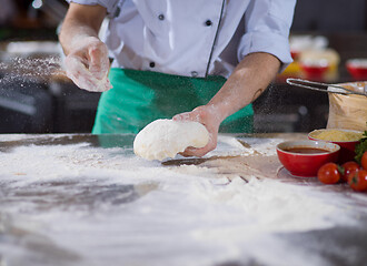 Image showing chef hands preparing dough for pizza