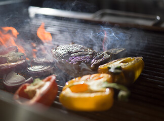 Image showing steak with vegetables on a barbecue