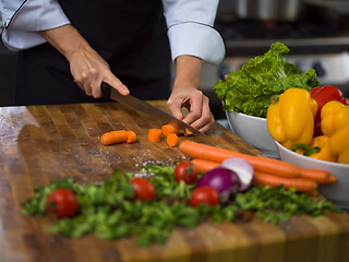 Image showing chef hands cutting carrots