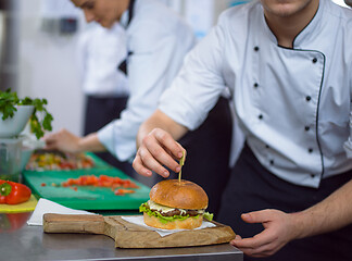 Image showing chef finishing burger