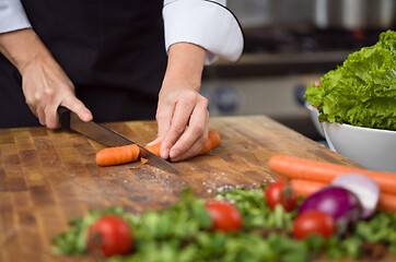 Image showing chef hands cutting carrots