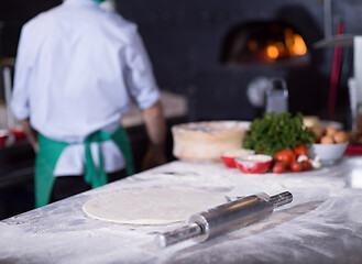 Image showing chef preparing dough for pizza