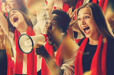 Image showing Group of happy fans are cheering for their team victory.