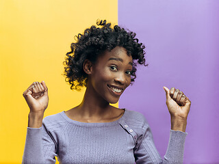 Image showing Winning success woman happy ecstatic celebrating being a winner. Dynamic energetic image of female afro model