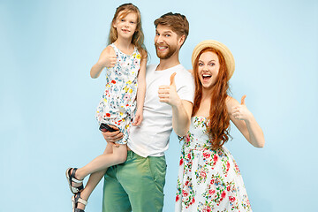 Image showing Happy parent with daughter at studio isolated on blue background