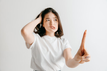 Image showing Woman\'s hand with finger on gray background