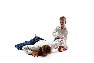 Image showing Man and teen boy fighting at aikido training in martial arts school