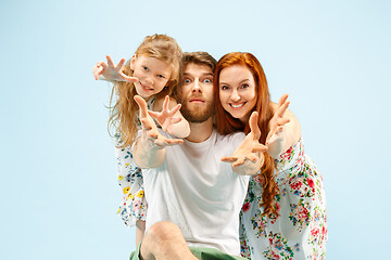 Image showing Happy parent with daughter at studio isolated on blue background