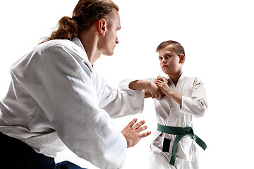 Image showing Man and teen boy fighting at aikido training in martial arts school