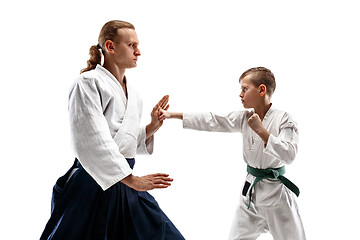 Image showing Man and teen boy fighting at aikido training in martial arts school