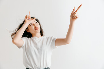 Image showing Losers go home. Portrait of angry woman showing loser sign over forehead