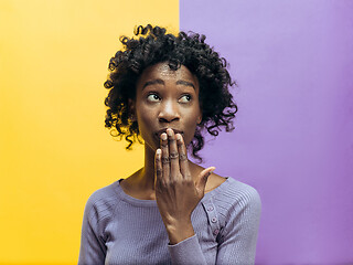 Image showing The young woman whispering a secret behind her hand