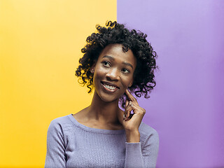 Image showing The happy african woman standing and smiling against gray background.