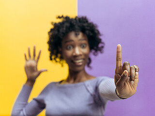 Image showing Woman\'s hand with finger on blue background