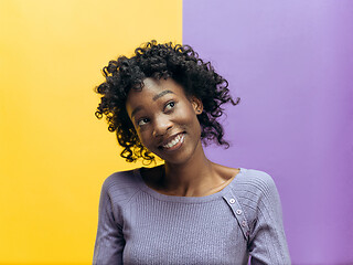 Image showing The happy african woman standing and smiling against gray background.