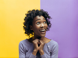 Image showing Winning success woman happy ecstatic celebrating being a winner. Dynamic energetic image of female afro model