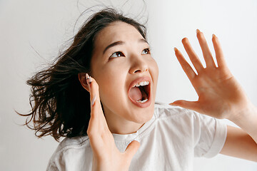 Image showing Isolated on pink young casual woman shouting at studio