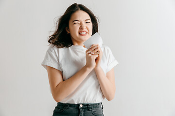 Image showing Young woman with a surprised expression won a bet