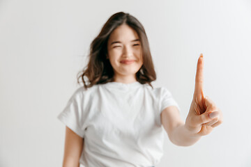 Image showing Woman\'s hand with finger on gray background