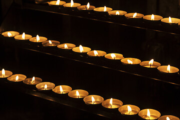 Image showing Burning candles in a church