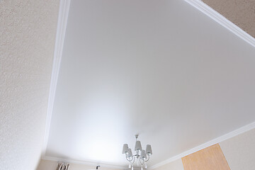 Image showing White matte ceiling in a large room close up