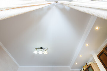 Image showing Two-level ceiling with a small chandelier in the interior of the room