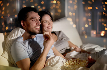 Image showing couple with popcorn watching tv at night at home