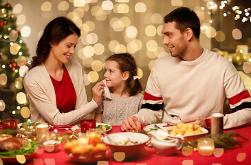 Image showing happy family having christmas dinner at home