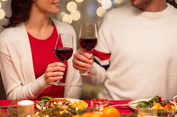 Image showing close up of couple drinking red wine on christmas