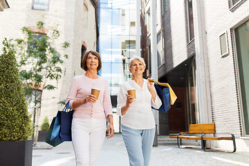 Image showing senior women with shopping bags and coffee in city