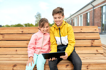 Image showing children with tablet computer sitting on bench