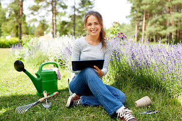 Image showing woman with tablet pc and garden tools in summer