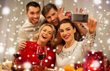 Image showing friends taking selfie at christmas dinner