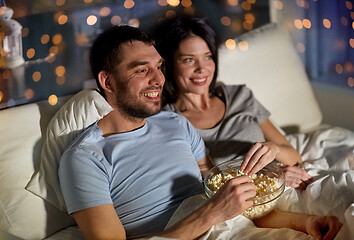 Image showing couple with popcorn watching tv at night at home