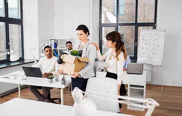 Image showing colleague soothing sad fired female office worker