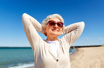 Image showing portrait of senior woman in sunglasses on beach