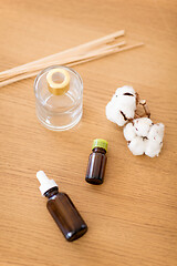 Image showing aroma reed diffuser, essential oil and cotton flower