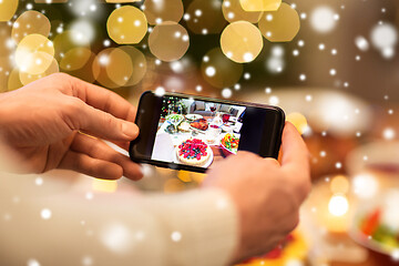 Image showing hands photographing food at christmas dinner